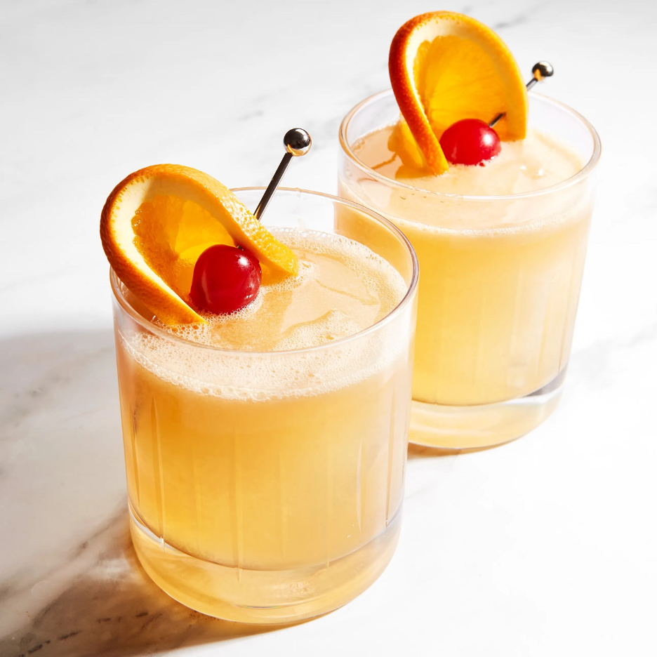 Whiskey Daisy cocktail in glasses with cherry and lemon garnish