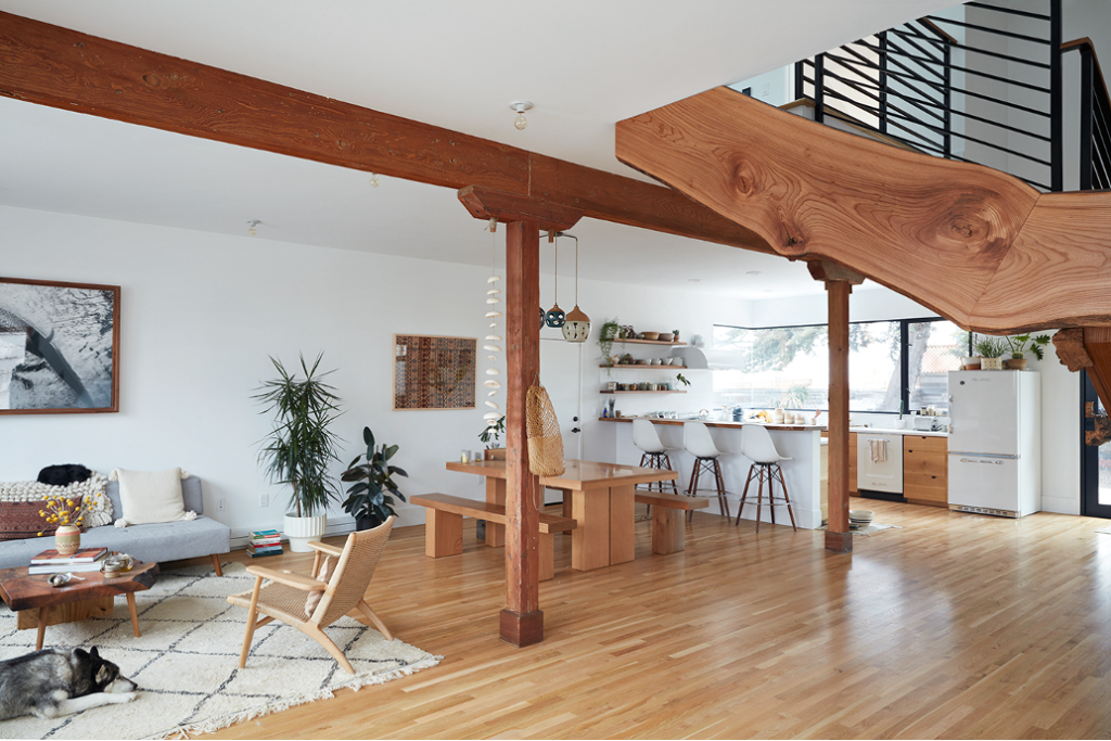 Interior beachside surf pad in San Francisco's Outer Sunst with ergonomic walnut live-edge staircase