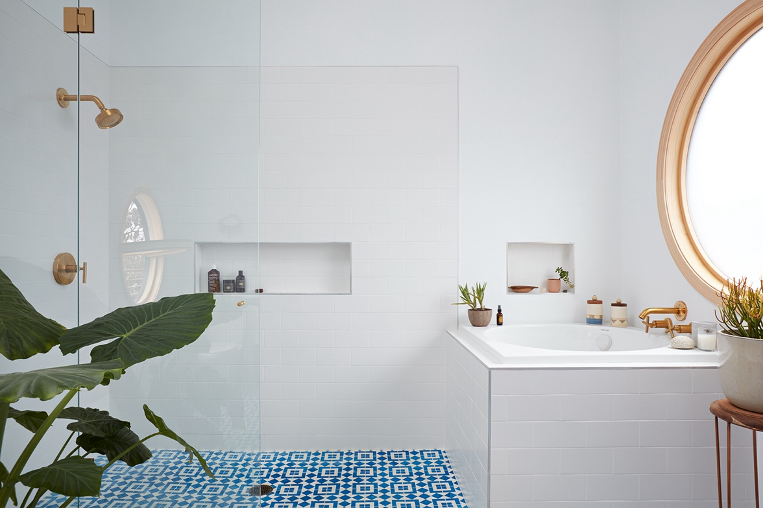 spa-style bathroom with tub and walk-in shower with Morroccan-inspired tile.