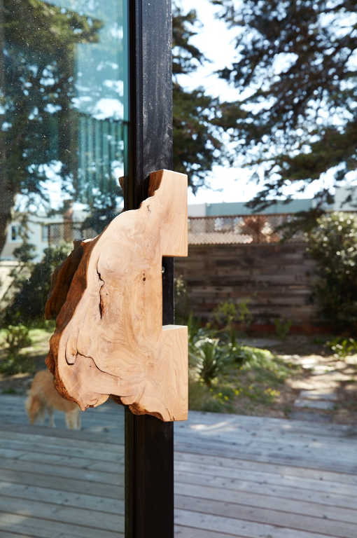 closeup detail of live-edge walnut door handle