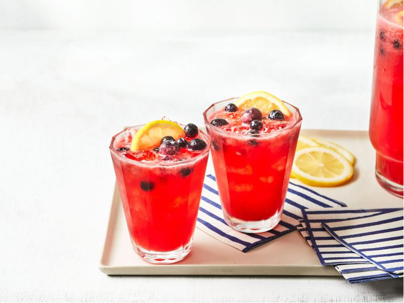 Firecracker Punch served in glasses with frozen blueberries, lemon slices