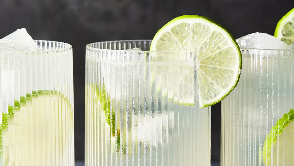 Gin Rickey's in ridged tall cocktail glasses with lime wheels.