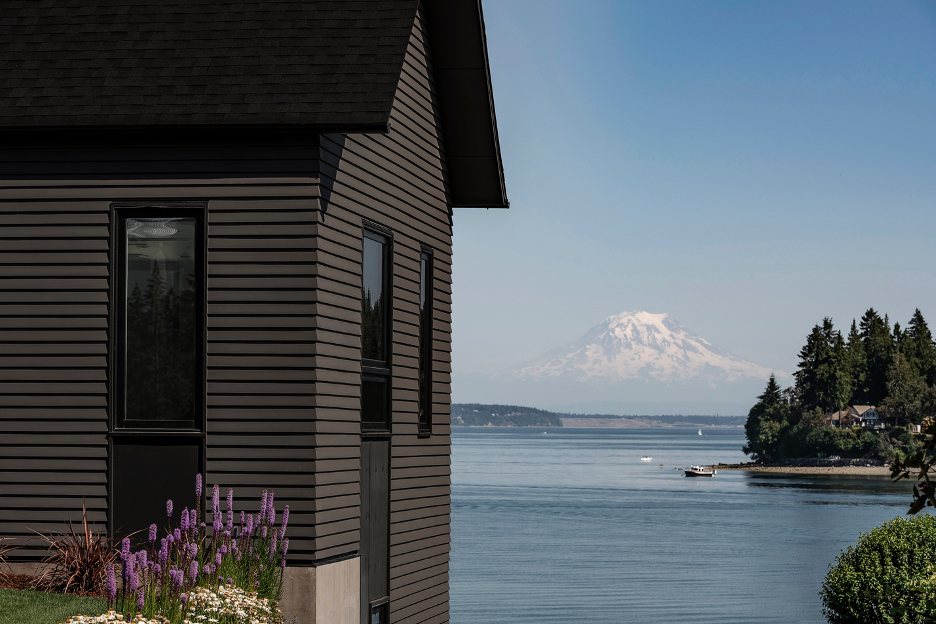 Exterior view of gabled structure and views of Puget Sound and Mount Rainier.