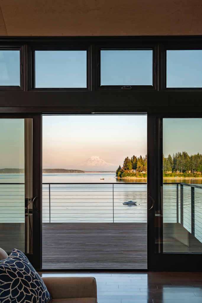 Closeup of sliding door leading out to the second-level deck with water views of Puget Sound and Mount Rainier in backdrop