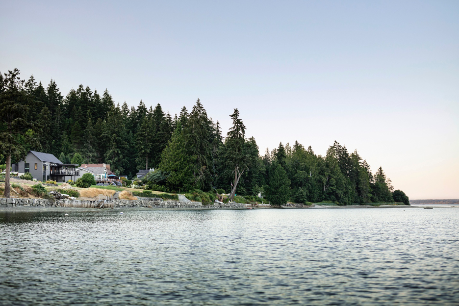 landscape view of Home House from the water in Puget Sound capturing the orientation of the structure