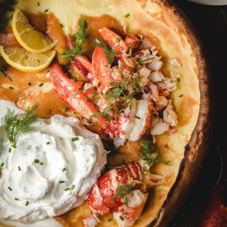 Lobster Dutch Baby pancake with Dill Whipoed Cream removed from skillet