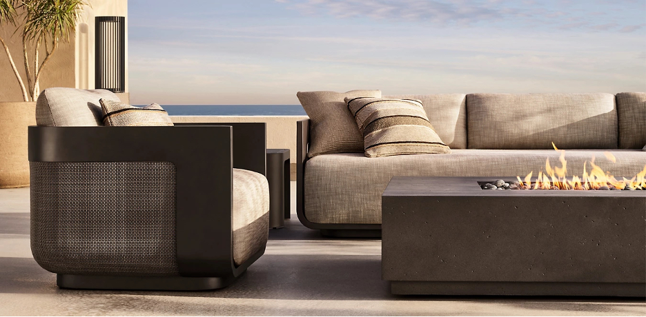 Restoration Hardware's Sedona Cane Collection with ocean backdrop and fire table 